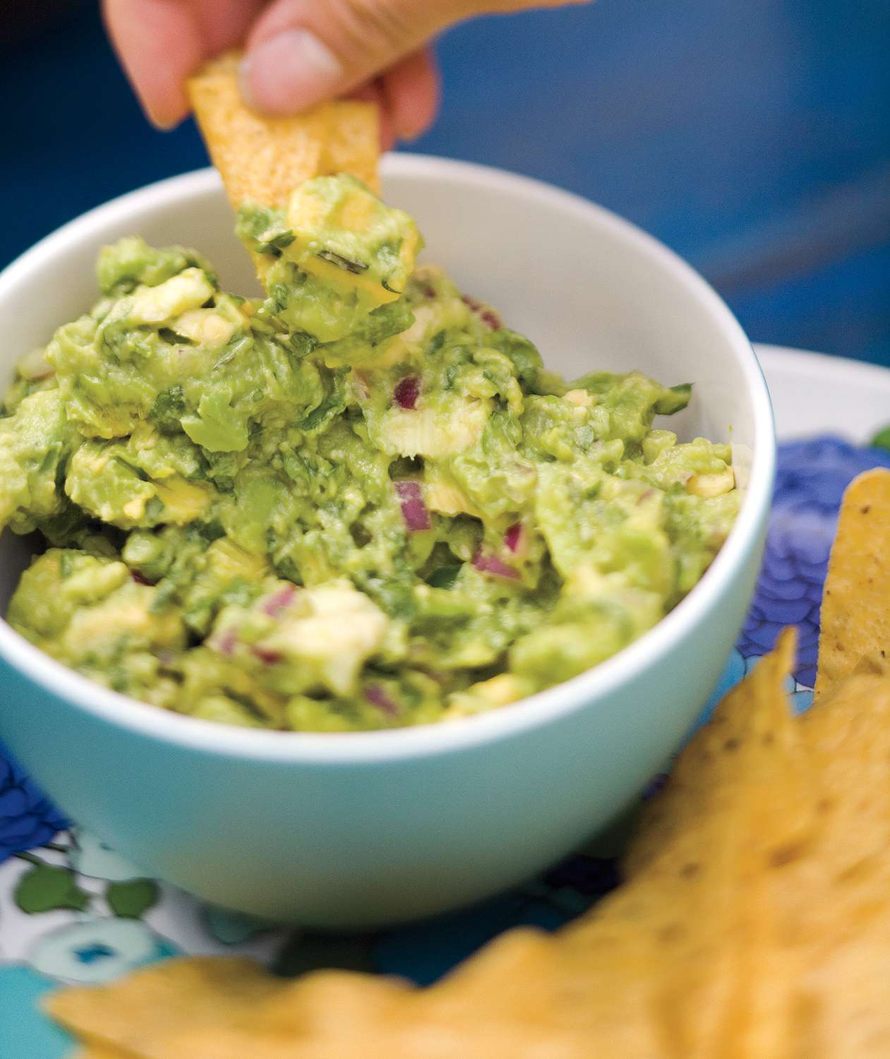 Guacamole and chips served on a platter.