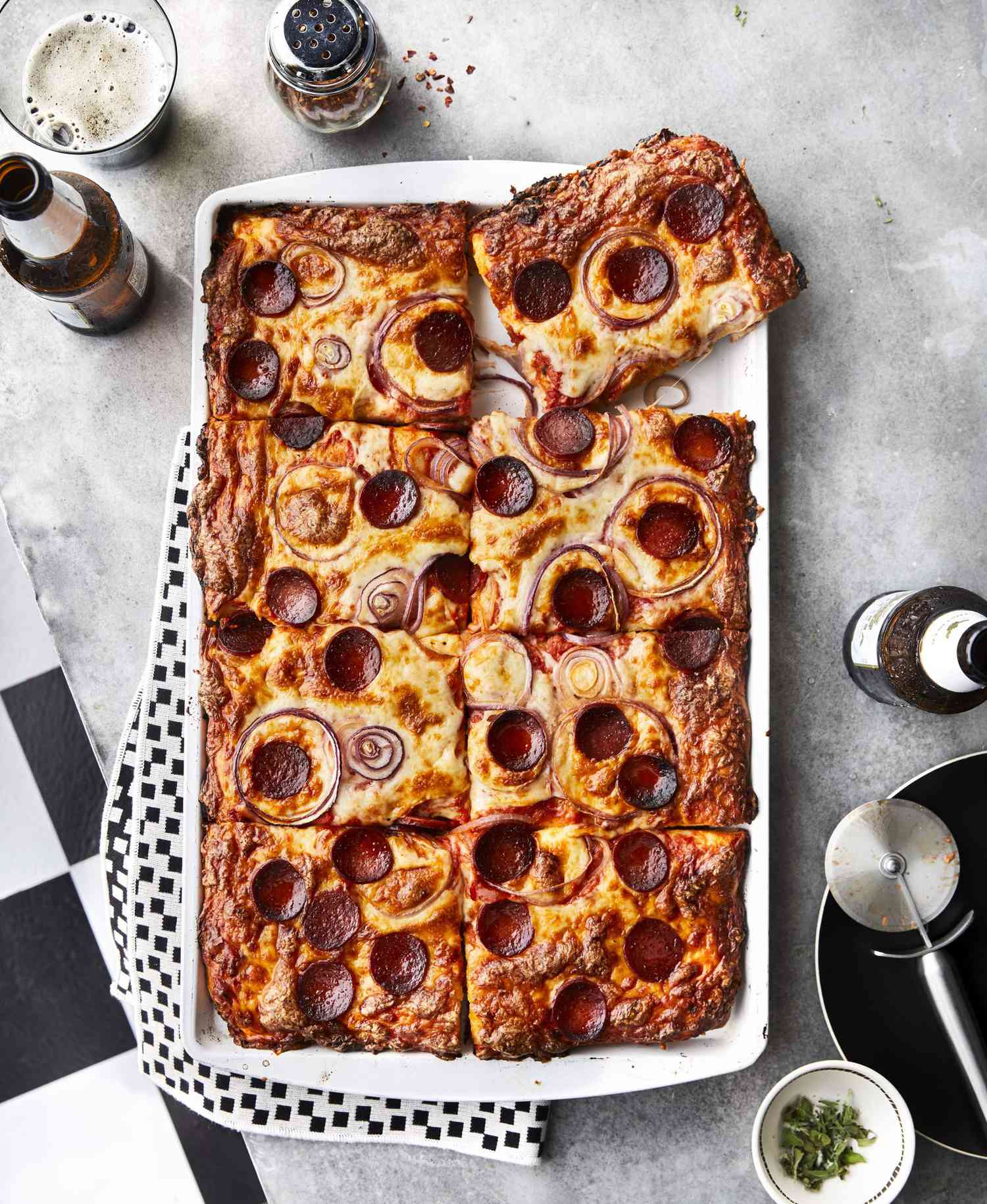 Rectangle Pizza With Pepperoni and Pink Sauce on a Baking Sheet and Cut into Squares