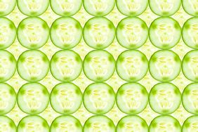 Close up of fresh cucumber slices (a hydrating food) arranged in rows