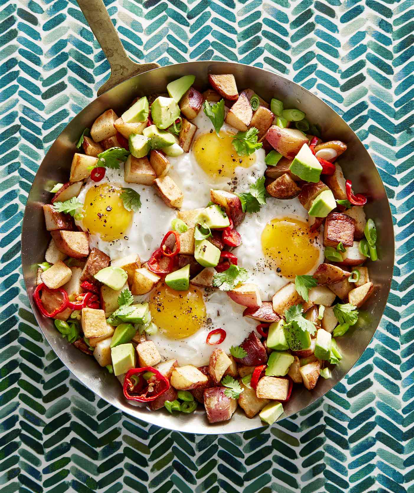 Potato, Egg, and Avocado Hash Served in a Metal Skillet