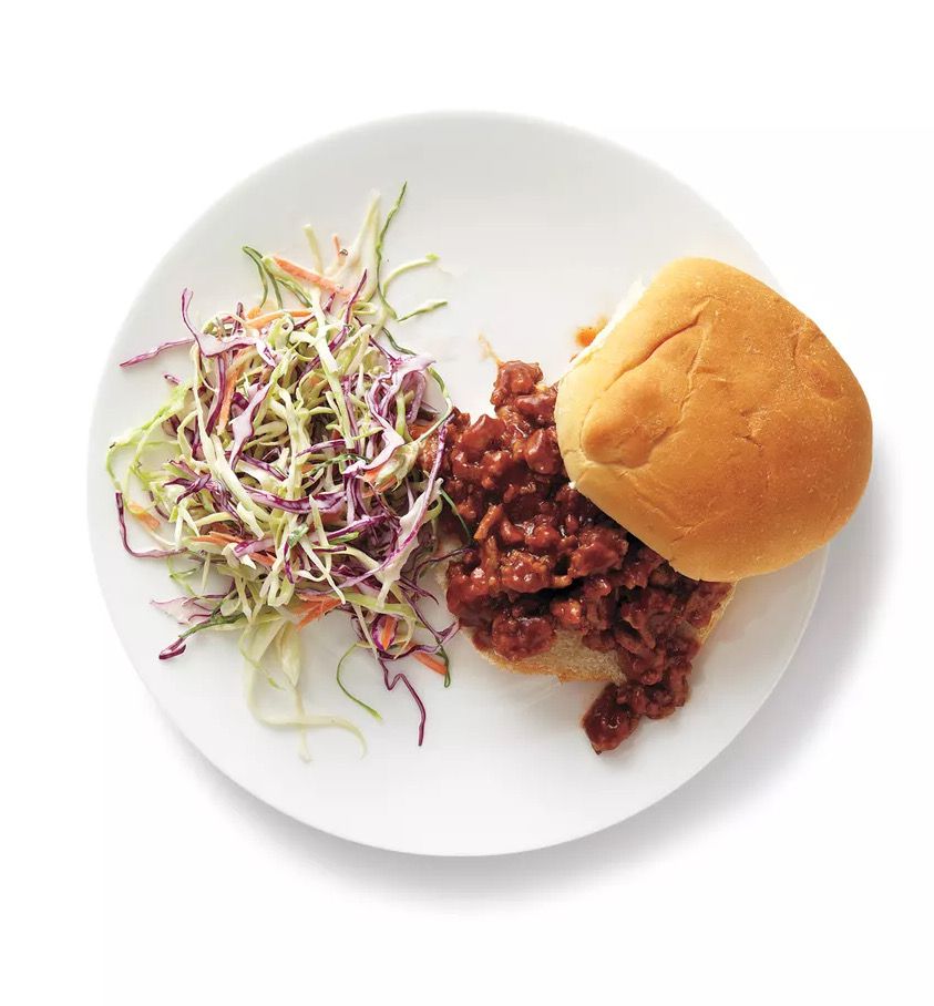 Overhead View of a Turkey Sloppy Joe Sandwich With Coleslaw on the Side, Served on a White Plate